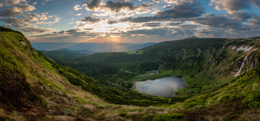 Panoramic view at mountain lake Maly Staw surrounded by green slopes at sunset © Jan