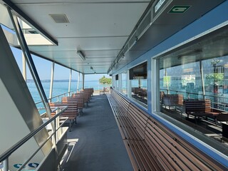 Fototapeta premium Scenic views from a ferry crossing on Lake Constance (Bodensee), featuring calm turquoise water, shoreline landscapes, ferry decks and clear summer weather in southern Germany.