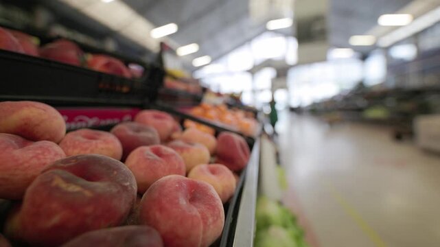 Fresh ripe saturn peaches on supermarket shelf