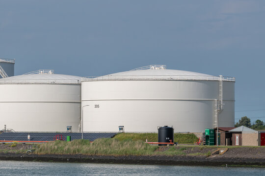 Vlissingen, Netherlands. Close-up of large oil and biofuel storage tanks with energy infrastructure at coastal industrial site
