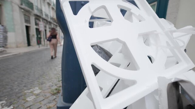 Discarded polystyrene packaging waste overflowing in a public trash can