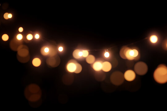String Lights with Warm Glowing Bokeh, glow softly against 