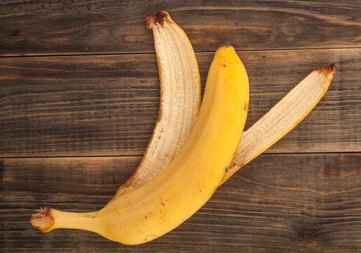 Banana peel on wooden background.