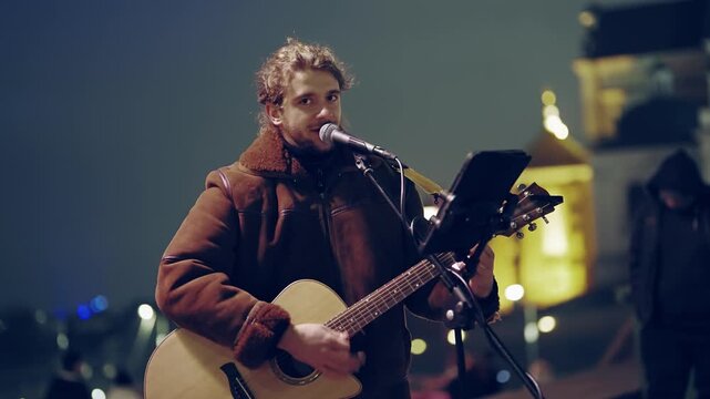Authentic Night Performance: Street Musician Sings in Warsaw