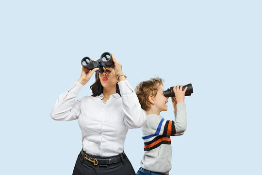 A happy mother and child with binoculars  ready for getting knowledge