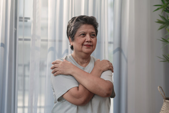 Senior Woman Practicing Self-Hug Breathing Exercise for Emotional Wellness