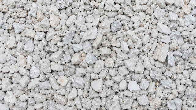 Top view of crushed white limestone gravel and rubble background
