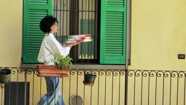 Italian Pizza Delivery: Woman Carries Fresh Order in Milan