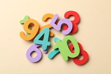 Fototapeta premium Different colorful numbers on beige background, flat lay