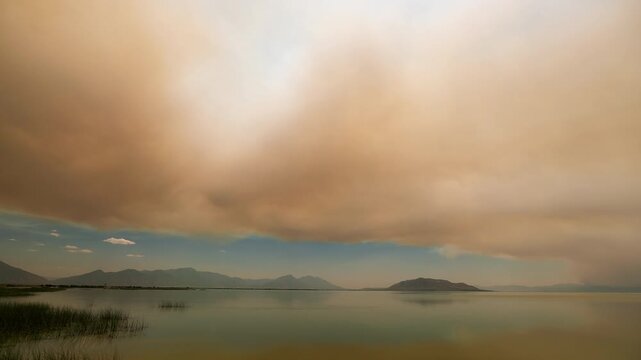 Timelapse of wildfire smoke moving over Utah Lake as fire burns around Eureka, Utah.