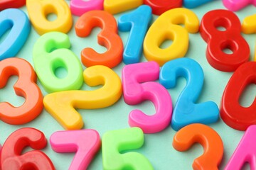 Fototapeta premium Many colorful numbers on turquoise background, closeup