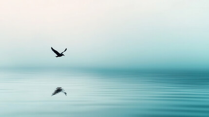 Obraz premium Serene bird flying over calm water reflects its silhouette in tranquil surface, creating dreamlike atmosphere