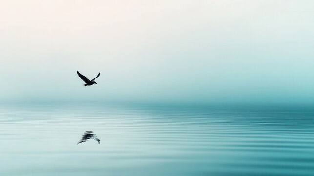 Serene bird flying over calm water reflects its silhouette in tranquil surface, creating dreamlike atmosphere