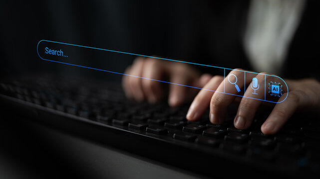 Close-up of hands typing on a keyboard with a futuristic search bar displayed above, symbolizing technology, innovation, and digital engagement in modern communication. Cyphers