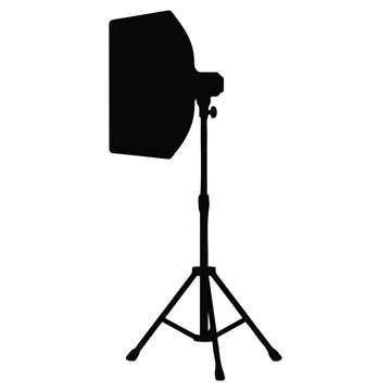 Black silhouette of a photography light on a tripod vector illustration.