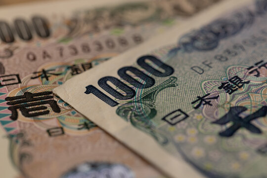 Japanese yen banknotes close up with ten thousand yen bill portrait