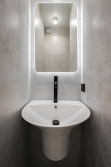 Fototapeta premium Faucet with ceramic sink with mirror in the bathroom