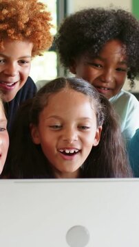 Vertical video: Alert on laptop drawing center girl leaning at home smiling in light top with peers