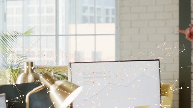 Presenter in office stepping on hand cue, gesturing, reviewing business data as overlay marks chart