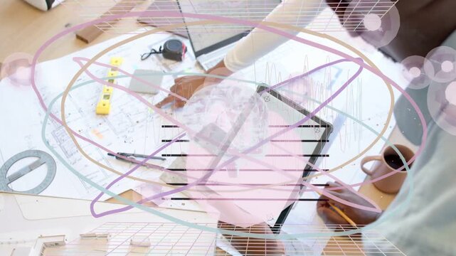 Designers reaching, adjusting plans on laptop for review, pencil and mug near, overlay over plans