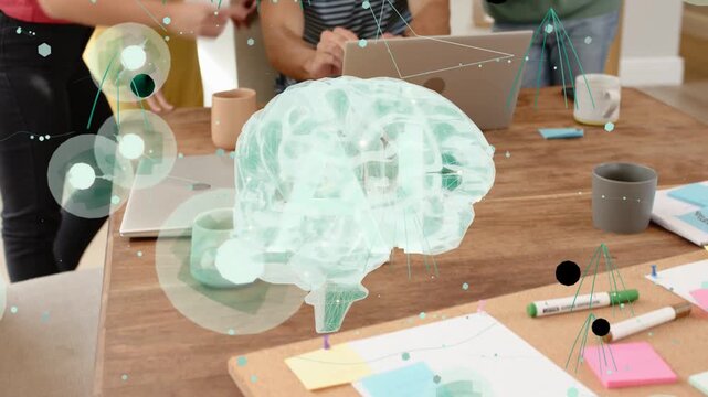Project team typing on laptop and pointing, using brain hologram over laptop for health research