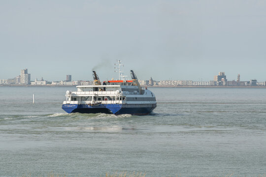 20 June 2026, Vlissingen, Netherlands. Passenger ferry departing harbor with coastal skyline and visible maritime emissions