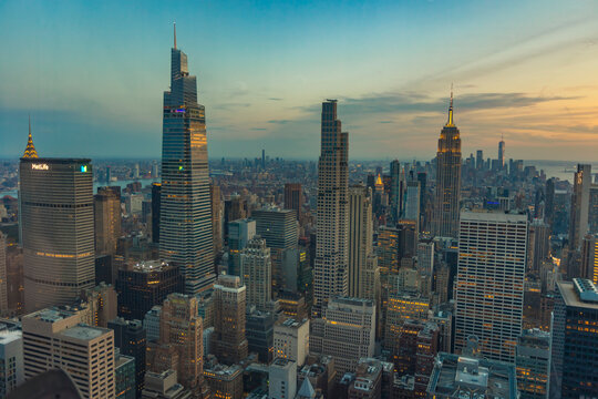 New York City, USA &ndash; April 13, 2026: Elevated view of Midtown Manhattan skyline with the Empire State Building at sunset as city lights begin to illuminate New York City.