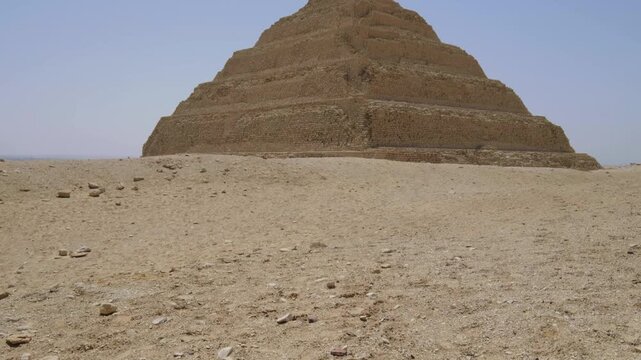 Slow motion 4K travel video showcasing the ancient Step Pyramid of Djoser rising from the desert landscape in Egypt.