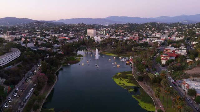 Aerial drone forward flight over Echo Park Lake toward Downtown Los Angeles at sunset, November 25 2025