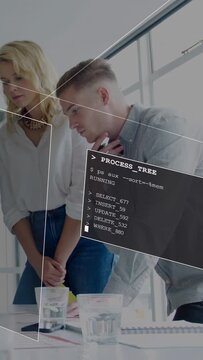 Vertical video: Man pointing pen and activating PROCESS_TREE HUD, team reviewing docs for planning