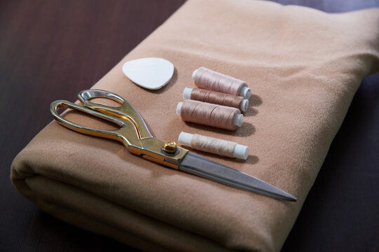 Group of sewing objects lying flat on a wooden table, concept of tailor shop