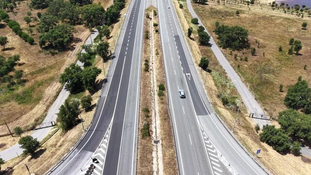 Multi-lane highway cutting through a semi-arid rural landscape