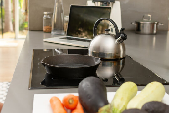Healthy cooking and remote work in modern open kitchen