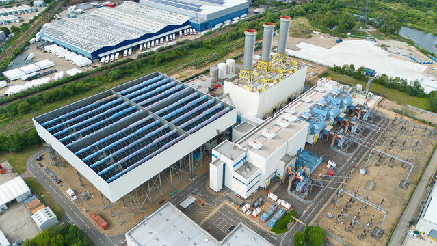 Aerial view of Rye House Power Station featuring its distinctive exhaust stacks, large cooling structures, and surrounding industrial facilities in Hoddesdon, England, United Kingdom.
