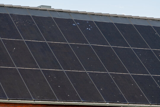 Breskens, Netherlands. Close-up of residential solar panels showing wear and dirt on photovoltaic surface