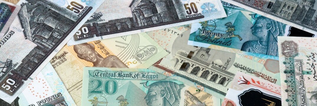 Egyptian pound money bills in pile on table. Egypt EGP currency cash close up