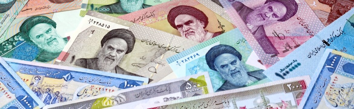 Iranian rial money bills in pile on table. Iran IRR currency cash close up. Concept of gambling