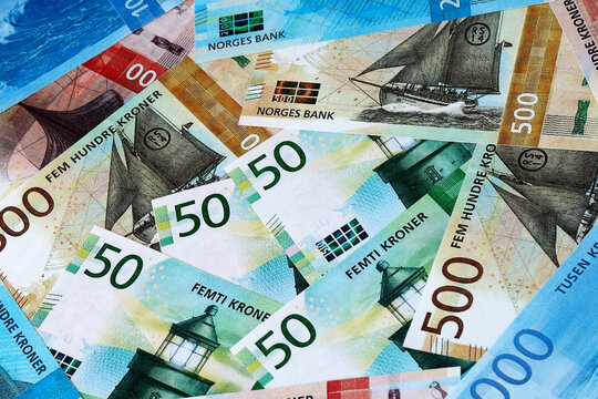 Norwegian krone money bills in pile on table. Norway NOK currency cash close up