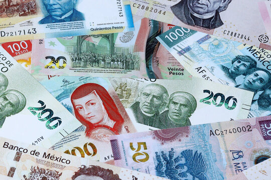 Mexican peso money bills in pile on table. Mexico MXN currency cash close up