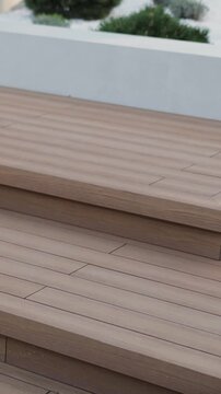 Vertical video. Composite decking terrace enhances modern outdoor living space and garden design.