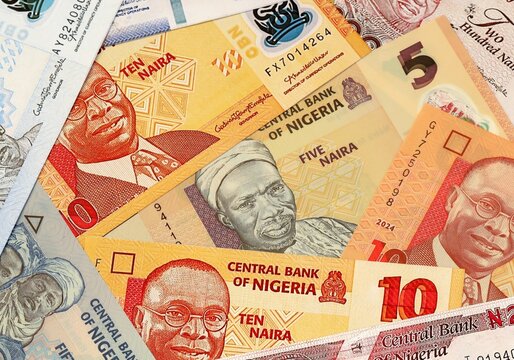 Nigerian naira money bills in pile on table. Nigeria NGN currency cash close up