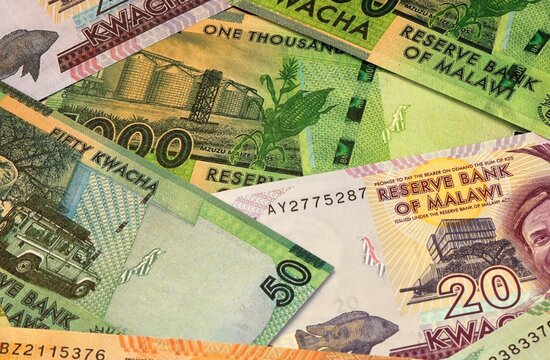 Malawian kwacha money bills in pile on table. Malawi MWK currency cash close up