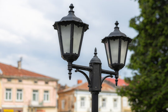 Vintage street lantern close up with blurred old town buildings in Drohobych Ukraine
