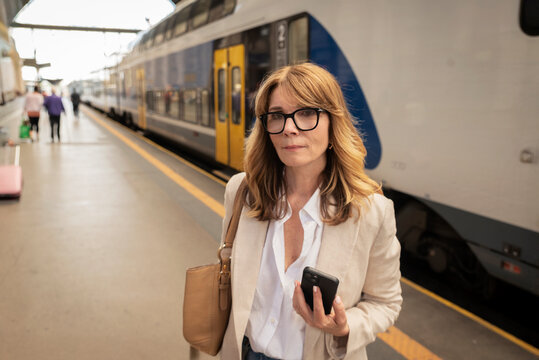 Mature woman waiting for train at railway station