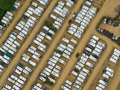 Aerial view of Weldon Caravan Storage showing rows of parked caravans and motorhomes on gravel lots in Weldon, England, United Kingdom.