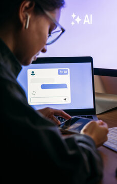 Young woman writing AI promt in a modern office.