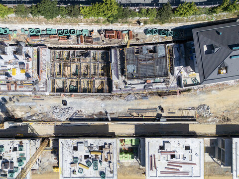 Aerial view of a construction site with concrete foundations, steel reinforcement bars, and building materials in Istanbul, Istanbul, Turkiye.