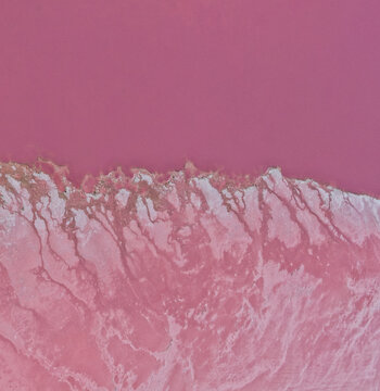 Aerial view of the vibrant pink waters and saline mineral deposits of Pink Lake, Western Australia, Australia.