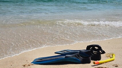 Diving mask, snorkel and flippers on the sand with sea wave in Portugal. Beach vacation. © LadyLensArt 