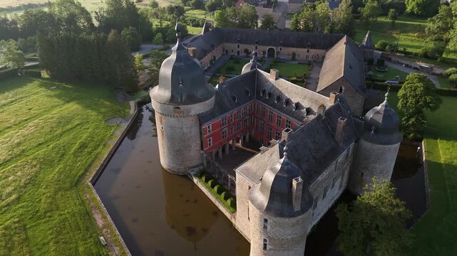 Belgium Ardennes chateau with moat aerial view morning